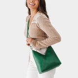 Bacalar Small | Model wearing petite shoulder bag with adjustable strap and magnetic snap closure