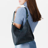 Boreal Small | Model wearing petite shoulder bag with adjustable strap and magnetic snap closure