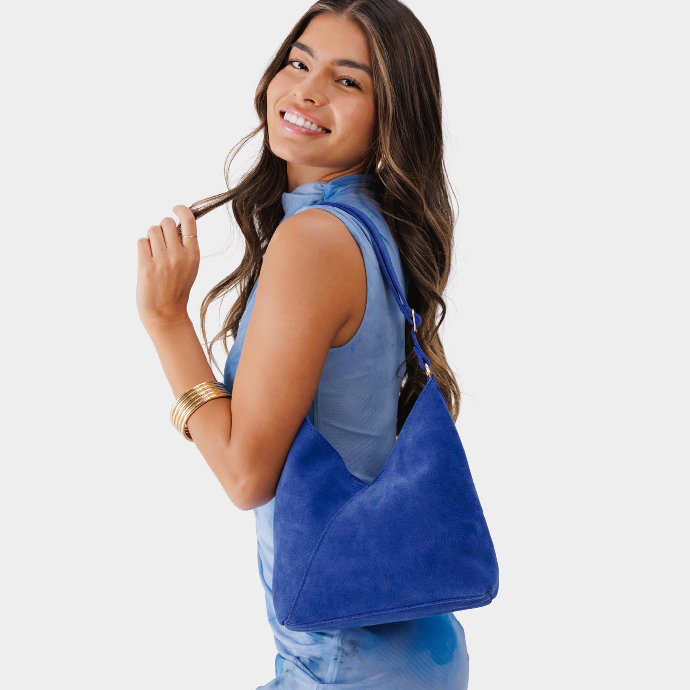 Joni Blue*Small | Model wearing petite shoulder bag with adjustable strap and magnetic snap closure