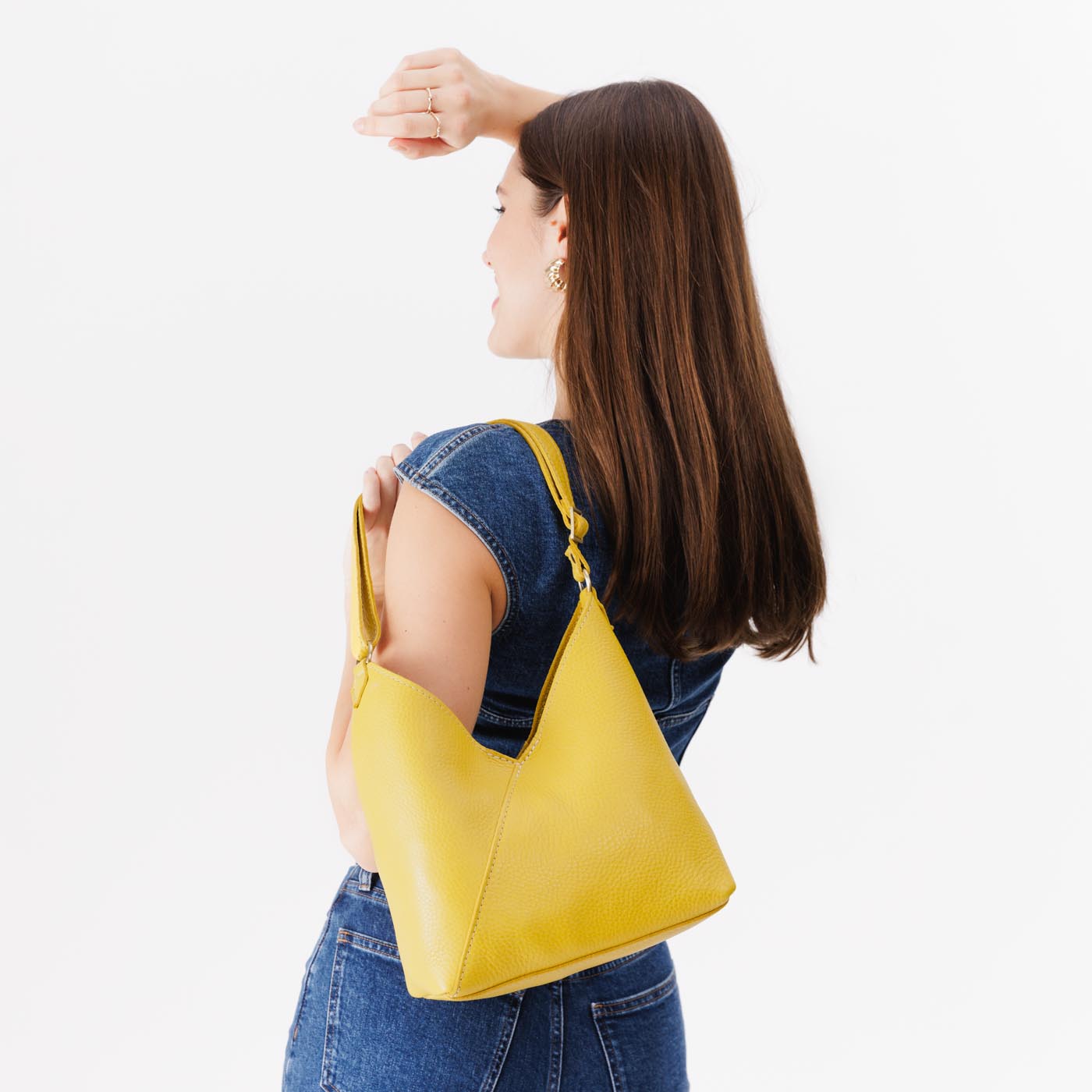 Naples*Small | Model wearing petite shoulder bag with adjustable strap and magnetic snap closure