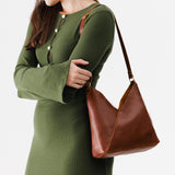 Nutmeg Small | Model wearing petite shoulder bag with adjustable strap and magnetic snap closure