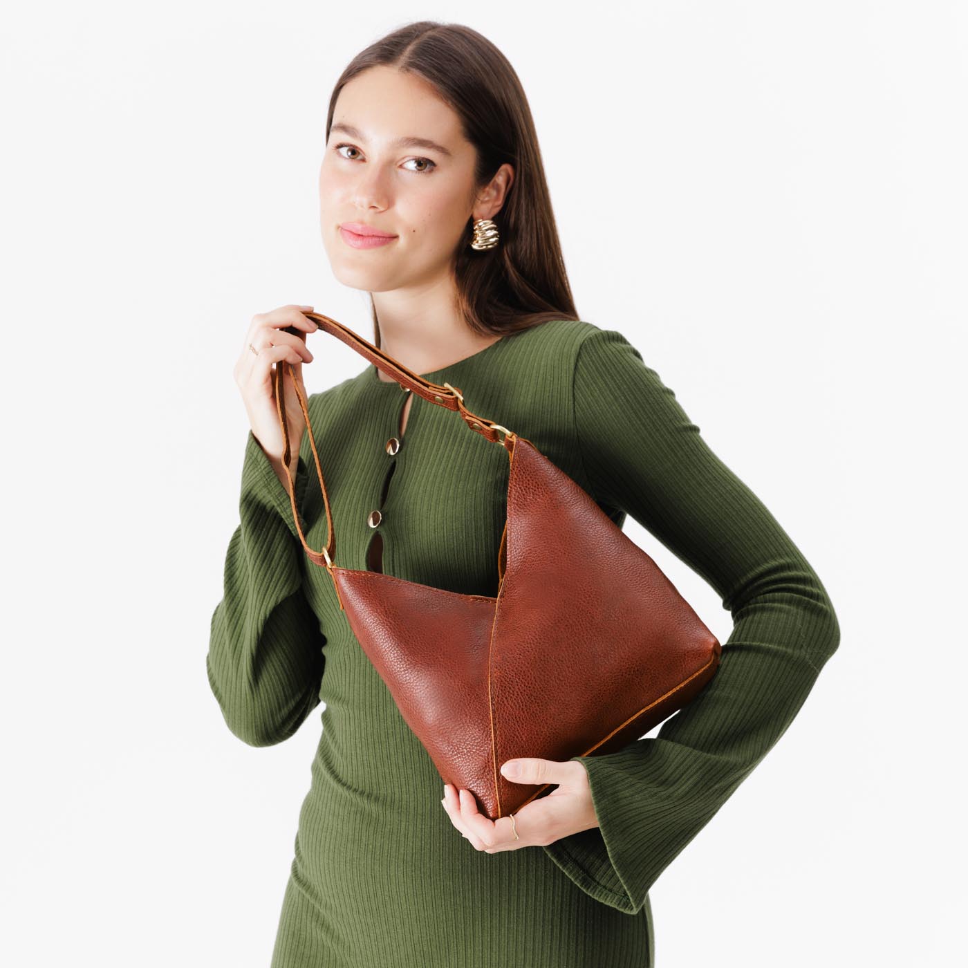 Nutmeg*Small | Model holding petite shoulder bag with adjustable strap and magnetic snap closure