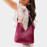 Orchid Small | Model wearing petite shoulder bag with adjustable strap and magnetic snap closure