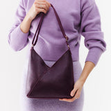 Plum Small | Model wearing petite shoulder bag with adjustable strap and magnetic snap closure