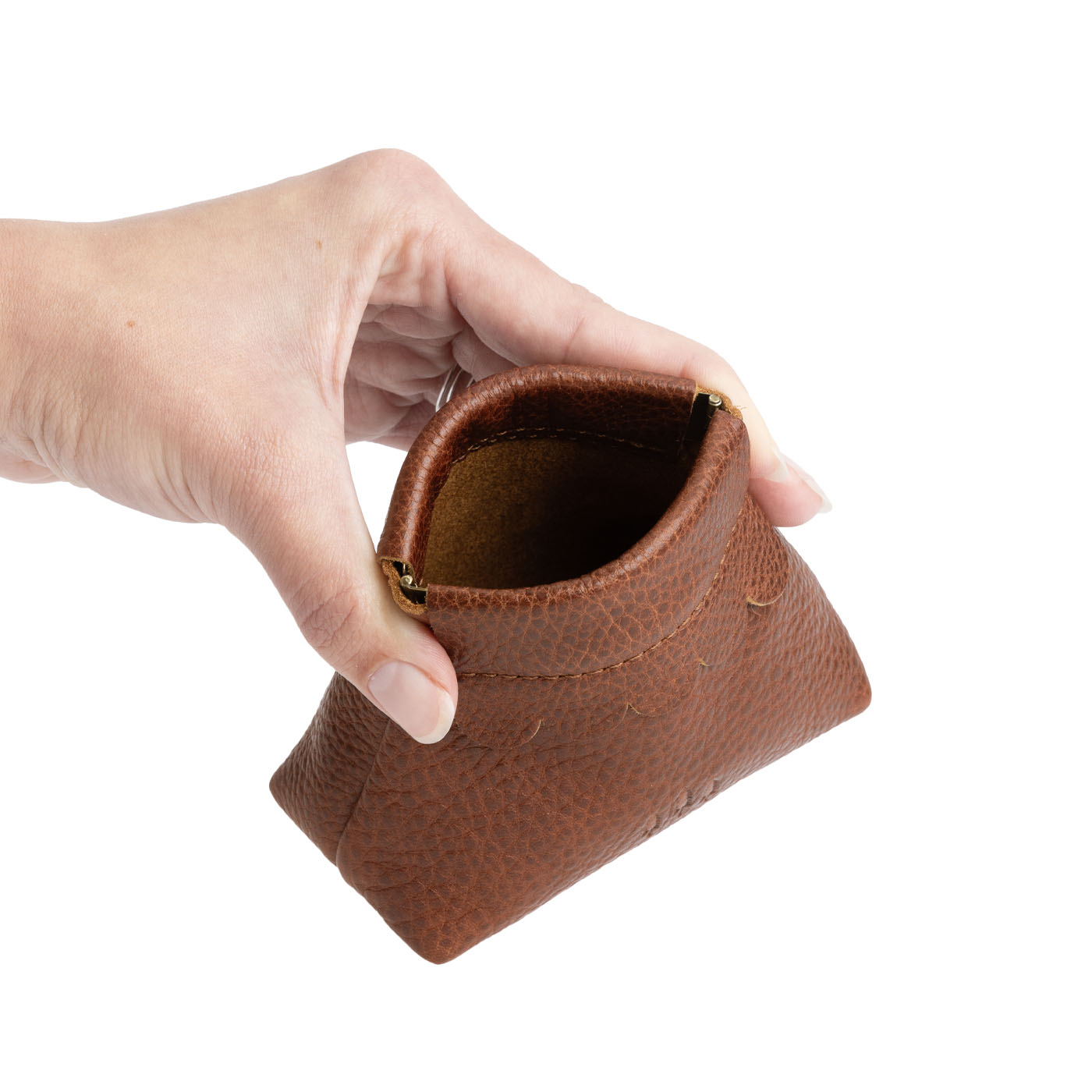 Nutmeg | Hand holding leather coin pouch with scalloped edge and three Portland leather tree emblems open