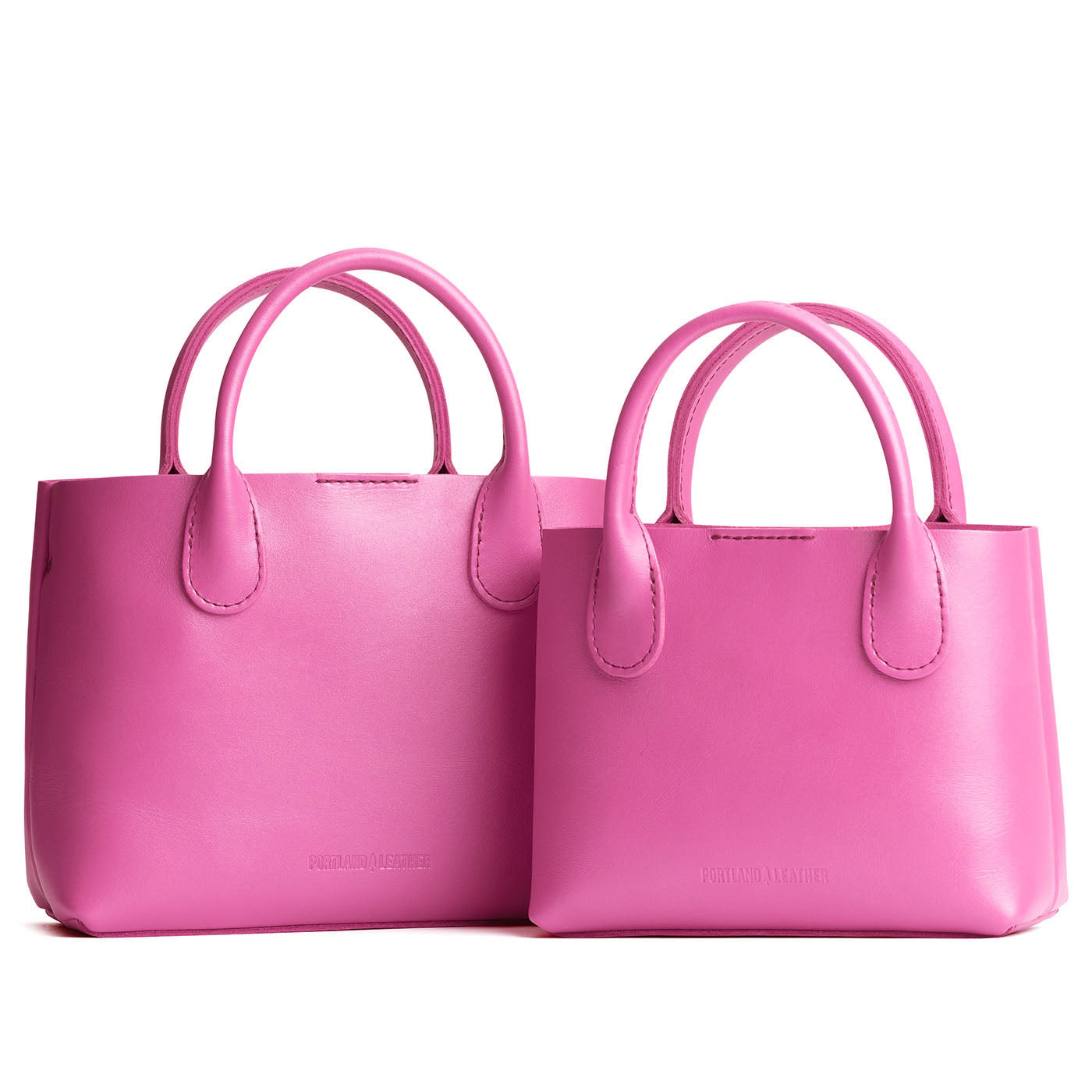 Lip Gloss | Side by side of both tote purses with structured leather handles and crossbody strap