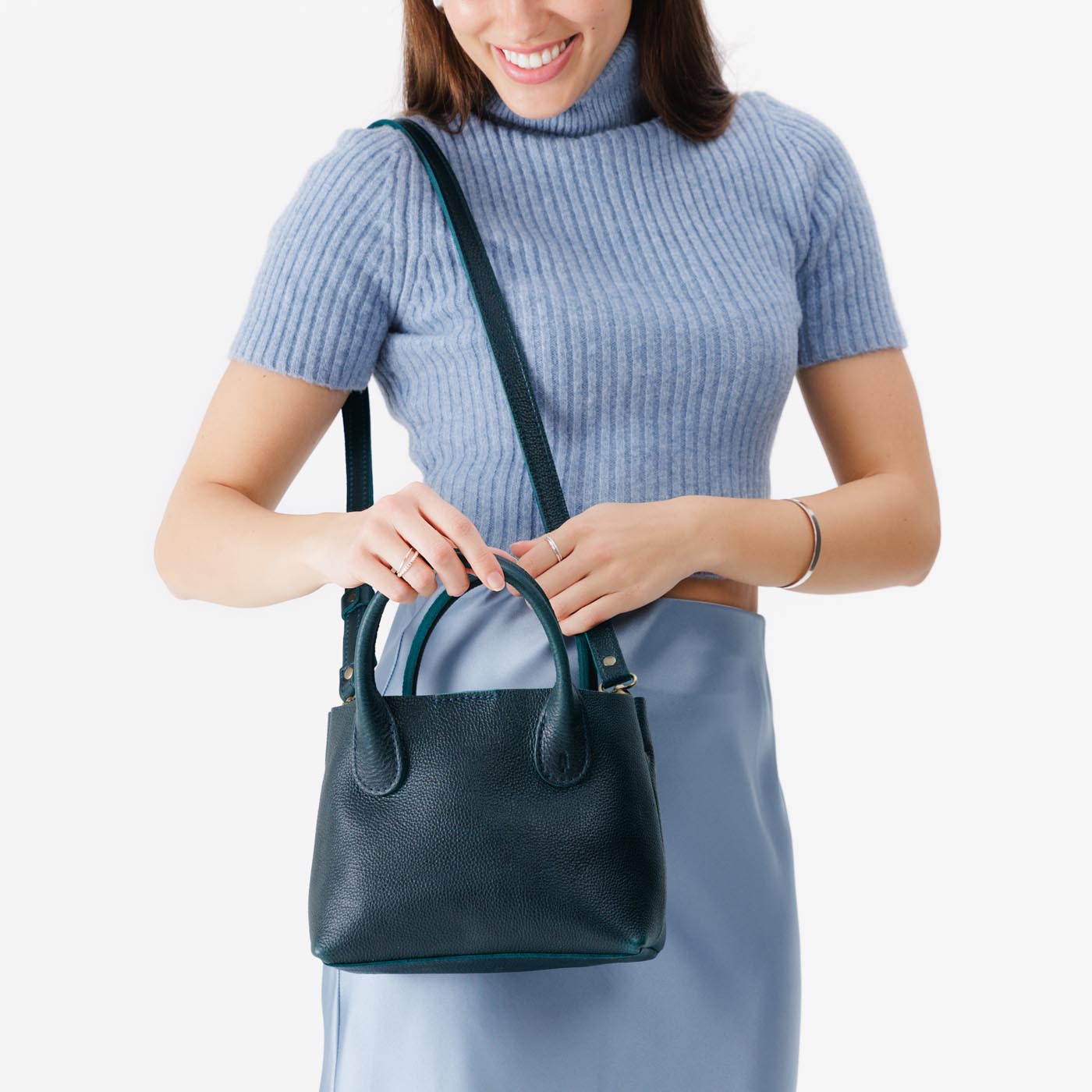 Boreal*Small | Model holding mid-size tote purse with  structured leather handles and crossbody strap