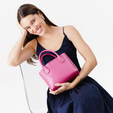 Lip Gloss Small | Model holding mid-size tote purse with  structured leather handles and crossbody strap