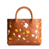 Folklore Honey Large | Mid-size tote purse with embroidered flower design, structured leather handles, and crossbody strap