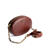 Cognac | Oval leather purse with metal crossbody chain strap and adjustable leather shoulder guard