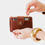 Nutmeg | Model holding compact wallet with snap closure and zippered pouch