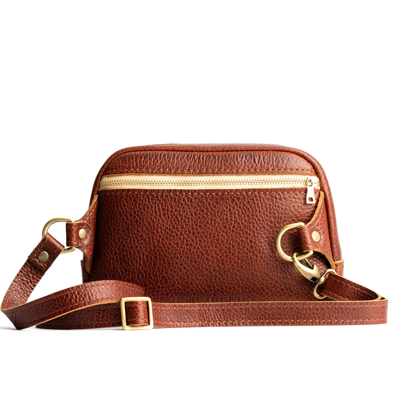 Nutmeg | Back of rectangular sling bag with zipper and tree logo