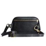 Pebbled--black | Back of rectangular sling bag with zipper pocket