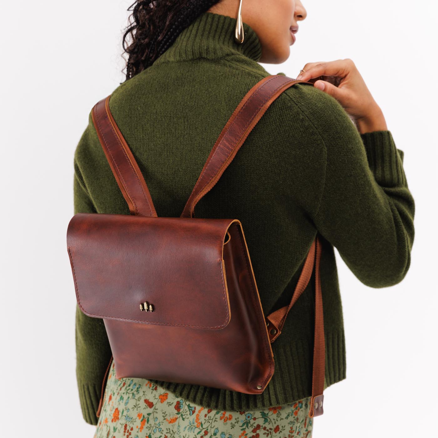 Timber | Model wearing rectangular backpack with leather lined nylon straps and magnetic flap closure