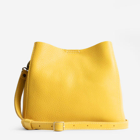 Naples | symmetrical bucket bag with latch closure and removable crossbody strap