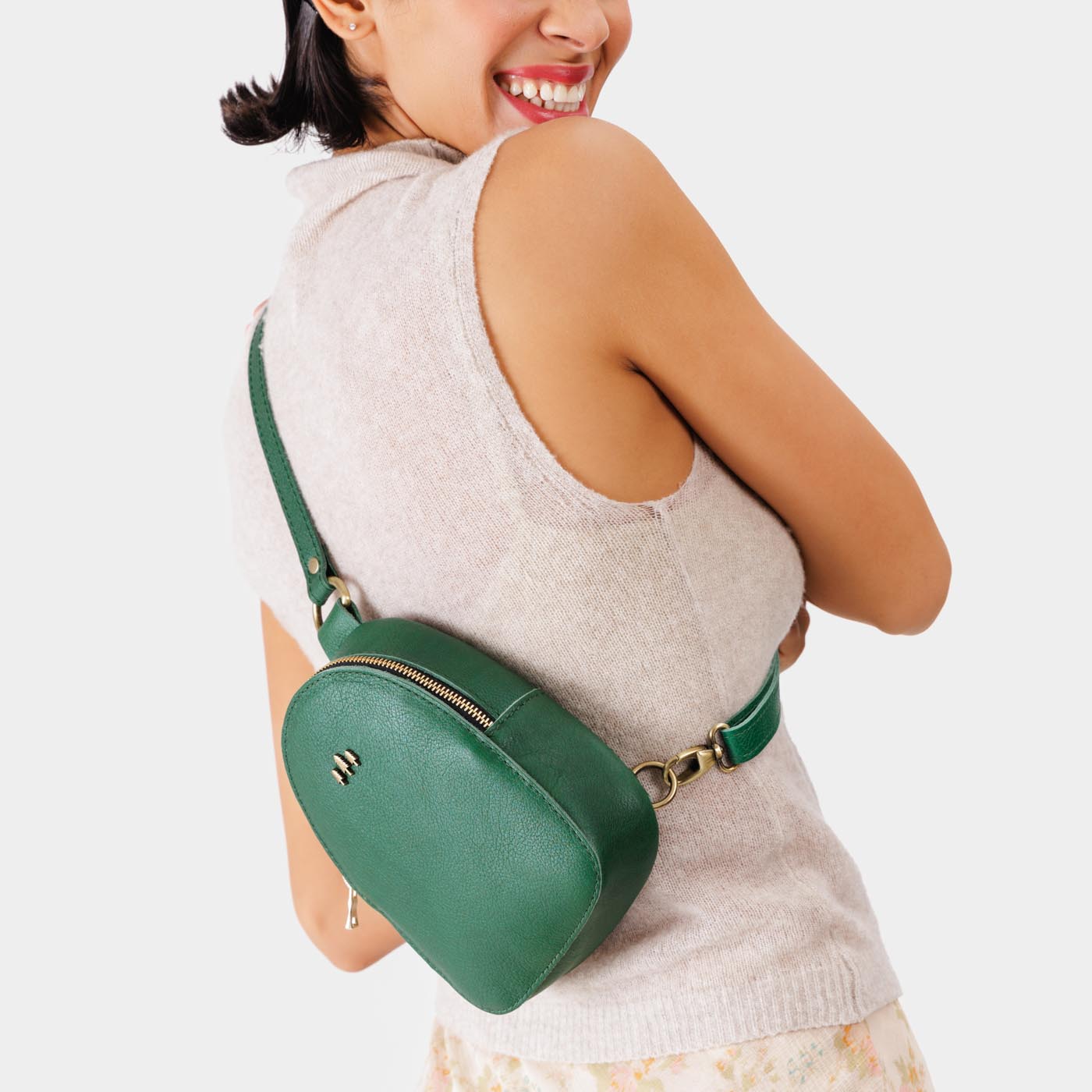 Bacalar | Model wearing small sling bag with zipper closure and adjustable strap