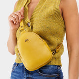 Naples | Model wearing small sling bag with zipper closure and adjustable strap