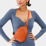 Tuscany | Model wearing small sling bag with zipper closure and adjustable strap