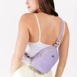 Wisteria | Model wearing small sling bag with zipper closure and adjustable strap on her back