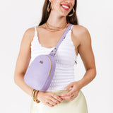 Wisteria | Model wearing small sling bag with zipper closure and adjustable strap on the front of her body