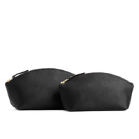 Black | Spacious leather makeup bag with curved seams and top zipper