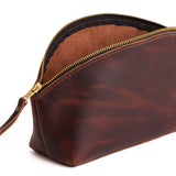 Lava | Spacious leather makeup bag with curved seams and top zipper
