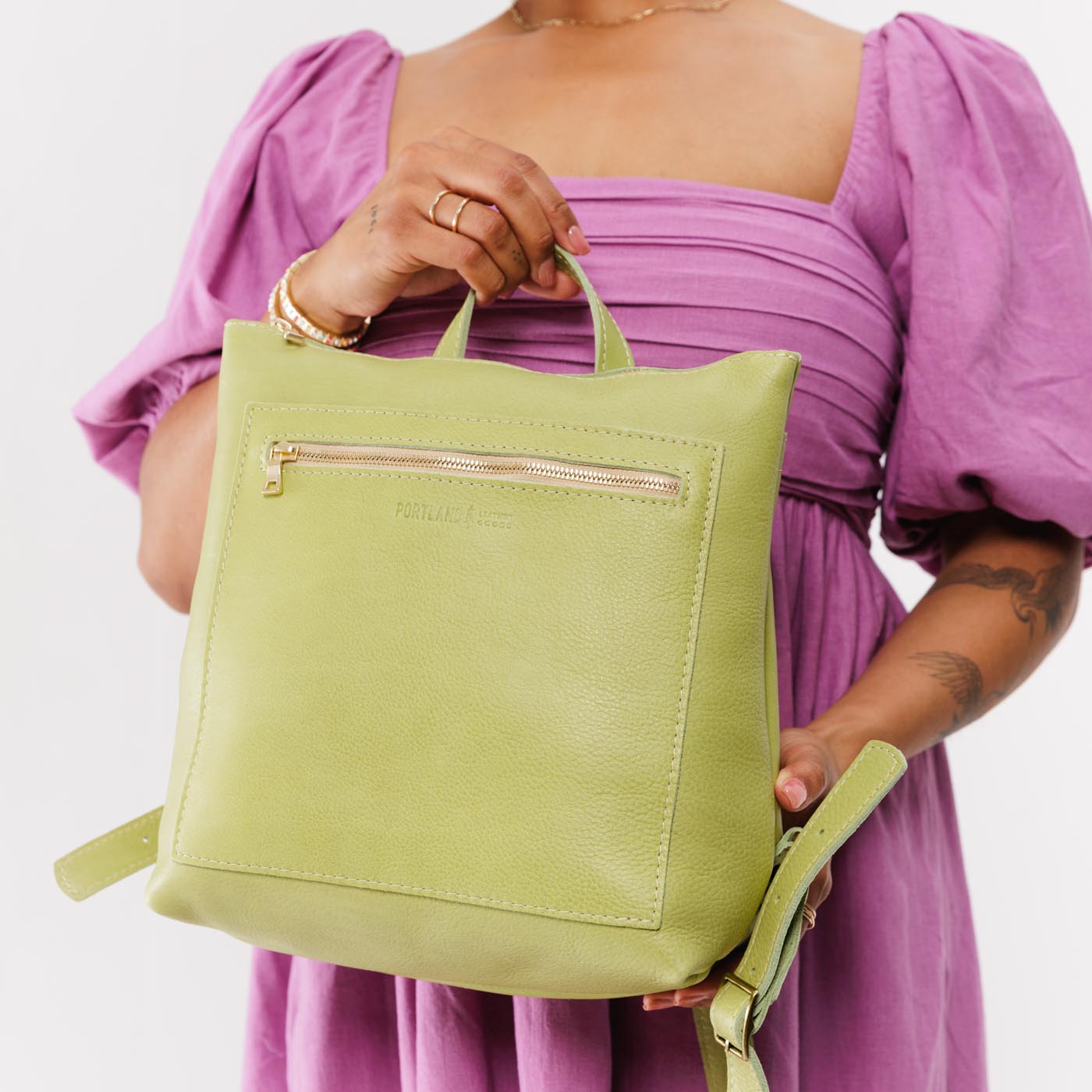 Sugar Snap | Model holding square slim leather tote backpack