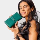 Peacock | Model holding leather wallet with Sam Browne closure