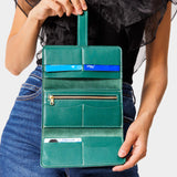 Peacock | Model holding leather wallet with Sam Browne closure open