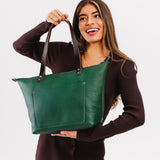 Bacalar Zipper | Model holding large zipper leather tote bag with sturdy bridle handles and front pocket