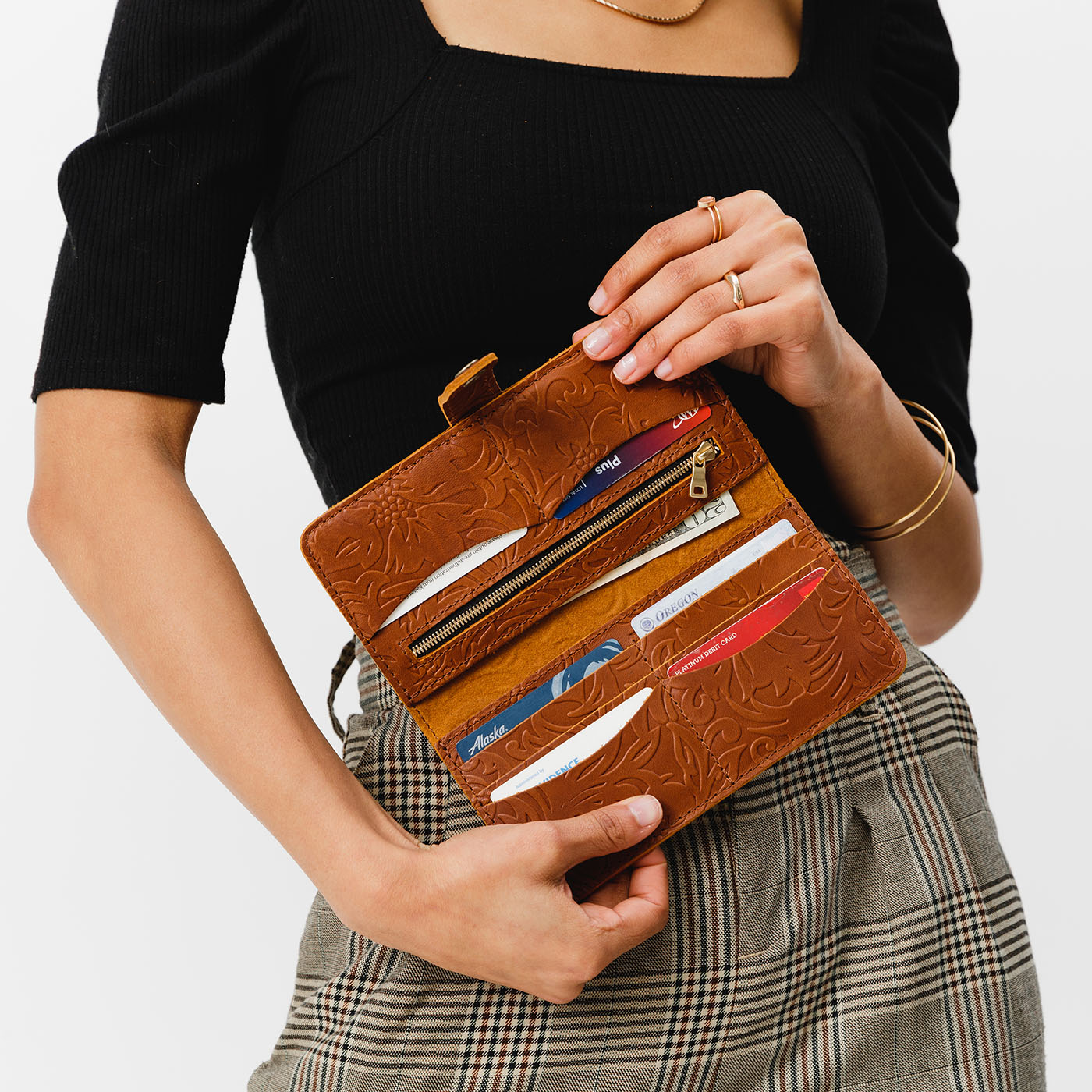 Meadow | Model holding leather wallet with snap open