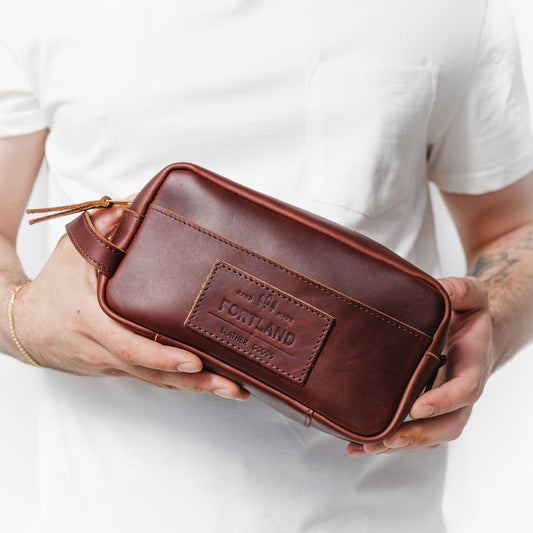 All Color: Cognac | Model holding large rectangular leather dopp kit