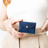 Deep Water | Model holding small leather wallet with scalloped edge